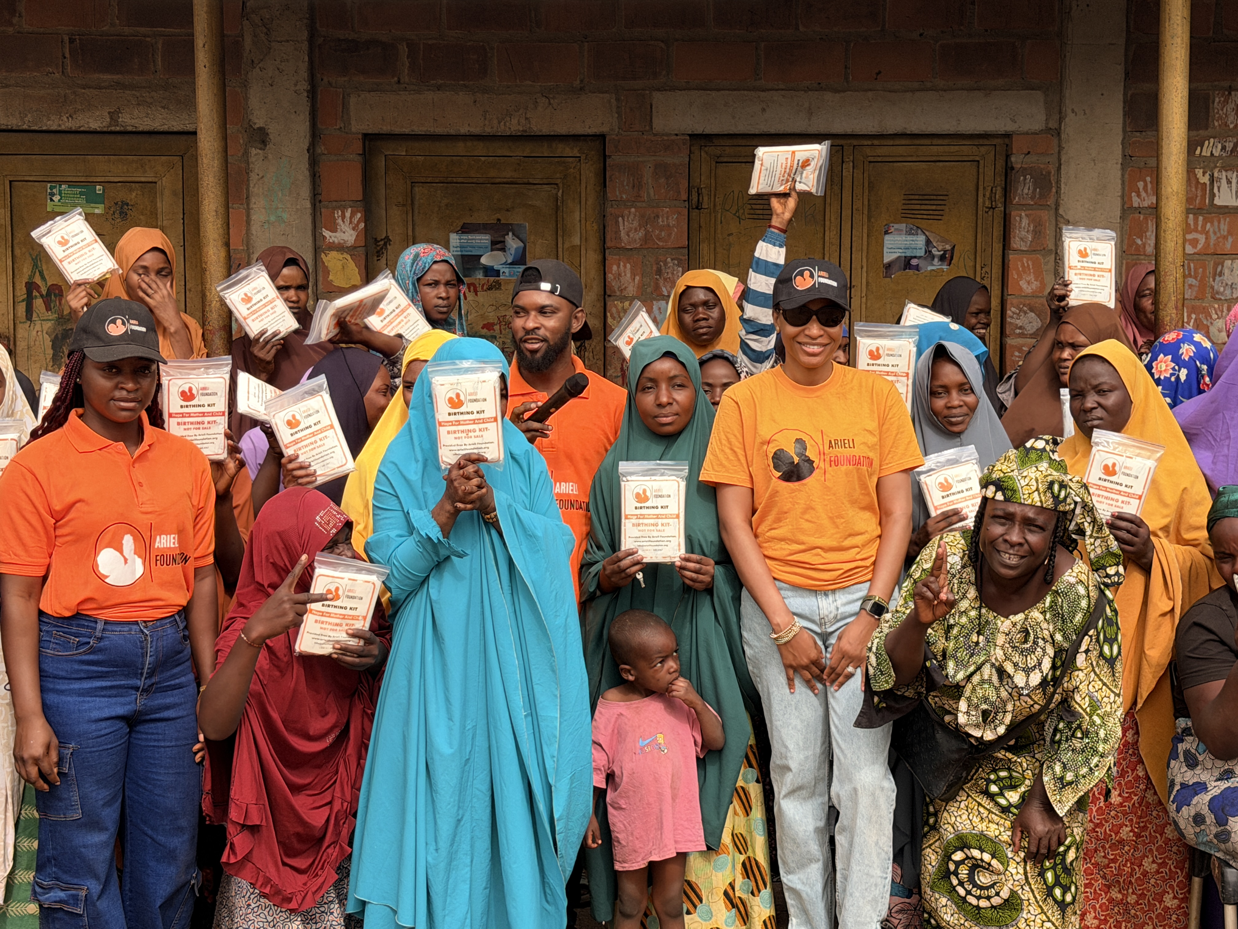 Arieli Foundation birthing kit distribution outreach - community members holding essential maternal health supplies